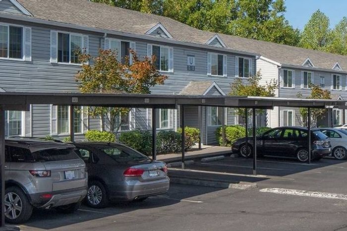 Exterior of building with carports and cars