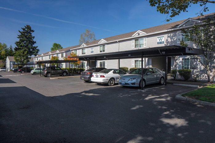 Exterior of building with carports and cars
