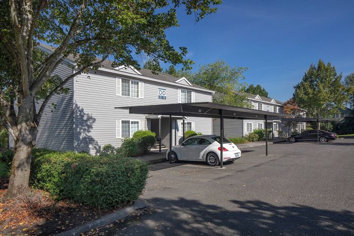 Exterior of building with carports and cars