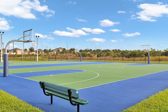 The basketball courts and sports facility near our Apopka homes, featuring basketball hoops and surrounding marshes.