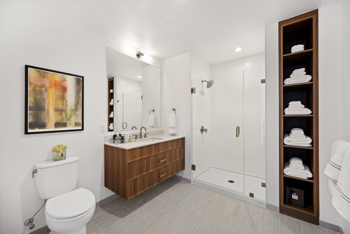 Walk-in tiled shower with frameless glass door