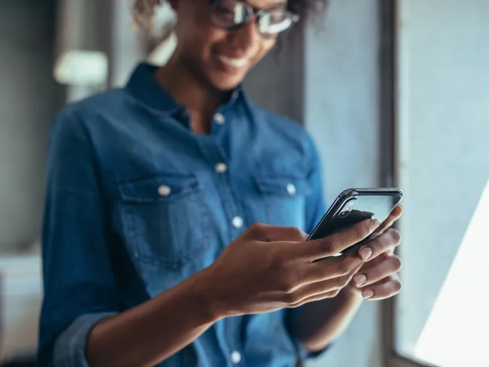 girl in denim shirt on cell phone