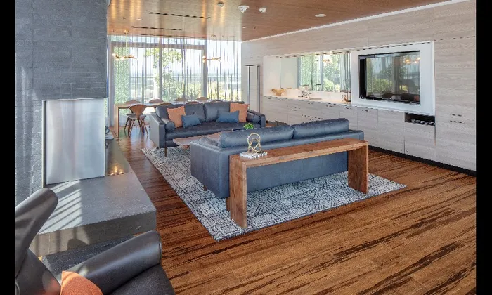 Rooftop lounge and common area at our apartments in Portland, OR, featuring chairs, a fire pit, and greenery.
