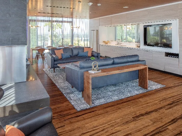 A sleek community lounge with modern lighting inside a downtown Portland apartment building.