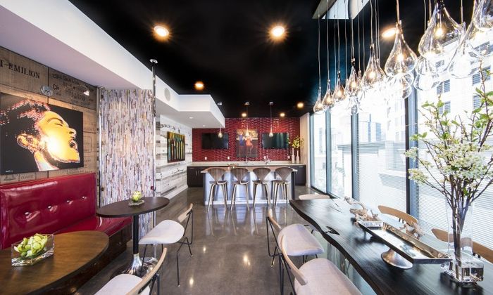 Lounge at our apartments in Atlanta, featuring a large dining table with chairs, booth seating, and elegant decor.