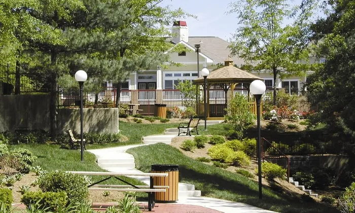 Park near our apartments for rent in Owings Mills, featuring a pagoda, benches, and path through grassy areas.