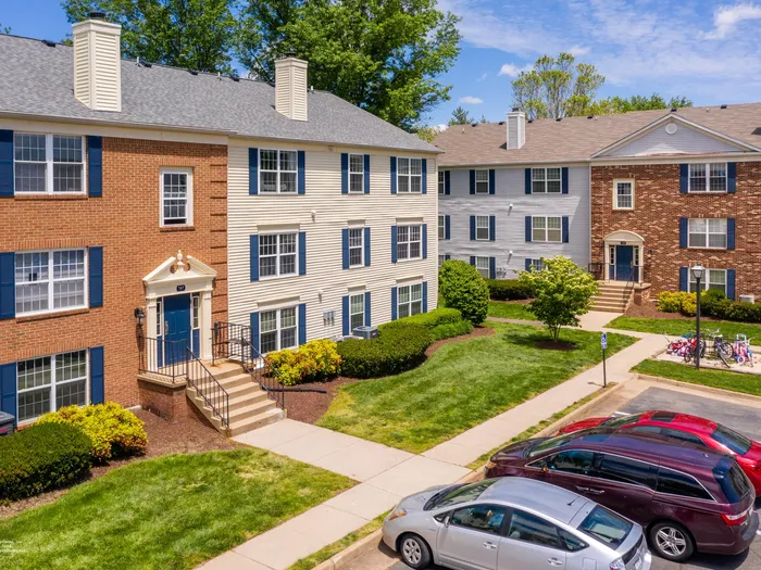 The exterior of our apartments for rent in Leesburg, VA, featuring a stately brick facade and a lawn.