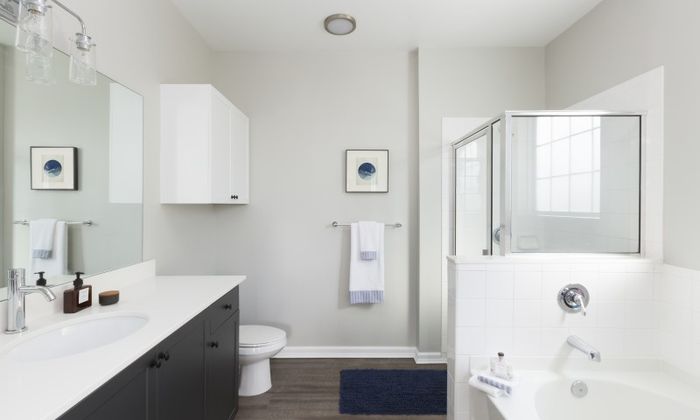 Marlborough MA apartment bathroom with wood cabinetry and walk-in shower.