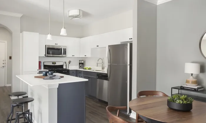 Marlborough MA apartment kitchen with wood cabinetry and stainless steel appliances.