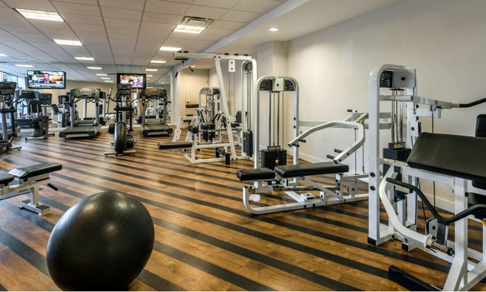 The fitness center at our apartments for rent in Washington DC, featuring assorted exercise machines.