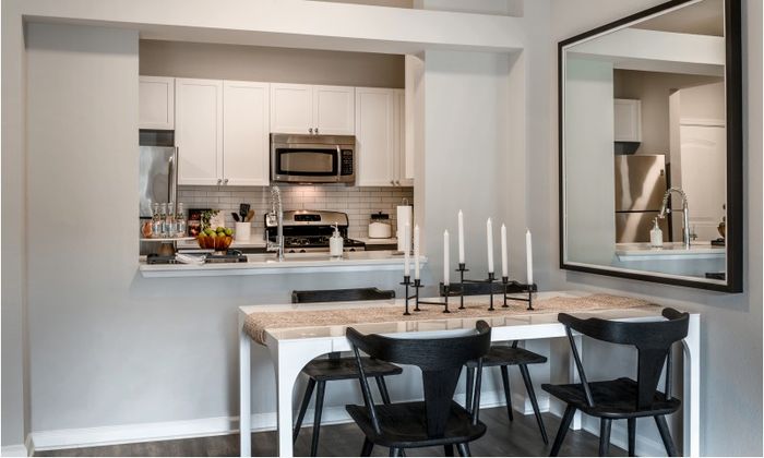 Model kitchen at our apartments for rent in Herndon, VA, featuring wood grain flooring and stainless steel appliances.