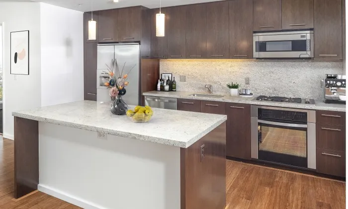 A luxury Portland Oregon apartment kitchen with a kitchen island and granite countertops.