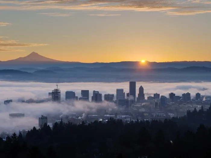 View of downtown Portland covered in mist at sunset.