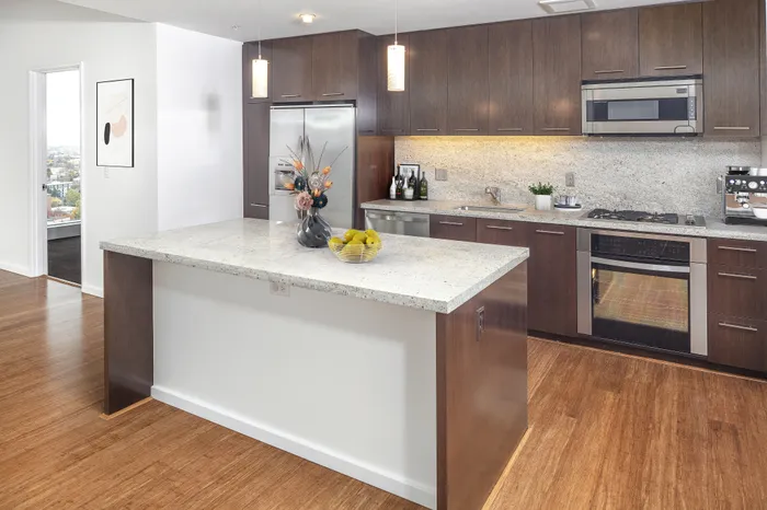 A luxury Portland Oregon apartment kitchen with a kitchen island and granite countertops.
