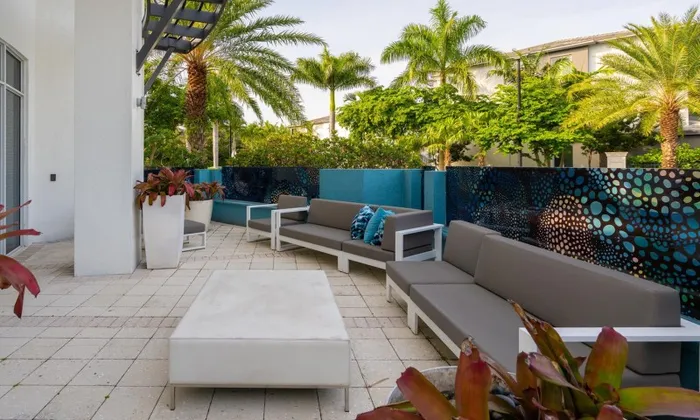 Outdoor lounge at our apartments for rent in Delray Beach, featuring outdoor seating and a potted plants