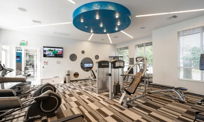 Various exercise machines inside a luxury Delray Beach apartment gym.