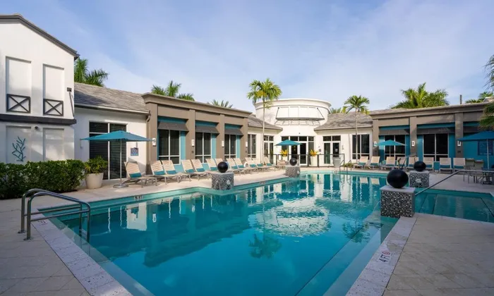 Daylight shot of a resort-style pool outside several downtown Delray apartments.