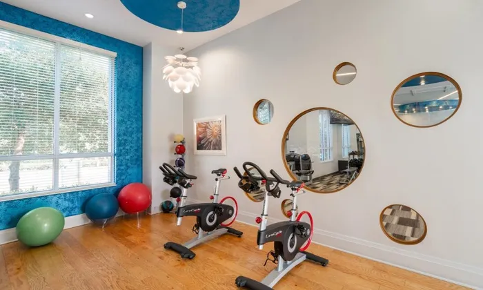 Spin cycles and exercise balls in a fitness center that is part of a downtown Delray apartment building.