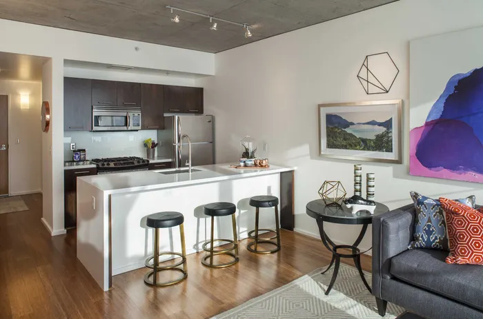 A luxury Portland Oregon apartment kitchen with a kitchen island and granite countertops.