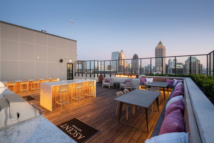 Rooftop lounge with outdoor kitchen, fireplace & spectacular views.