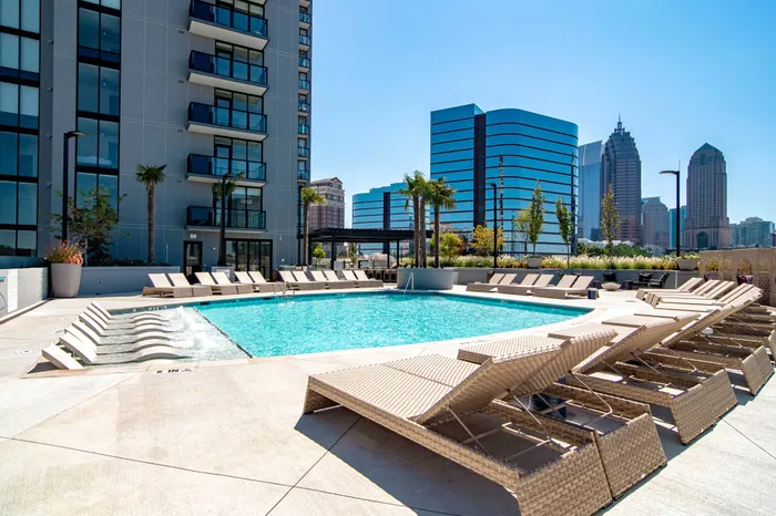 Luxe pool with chaise lounges and cabanas.