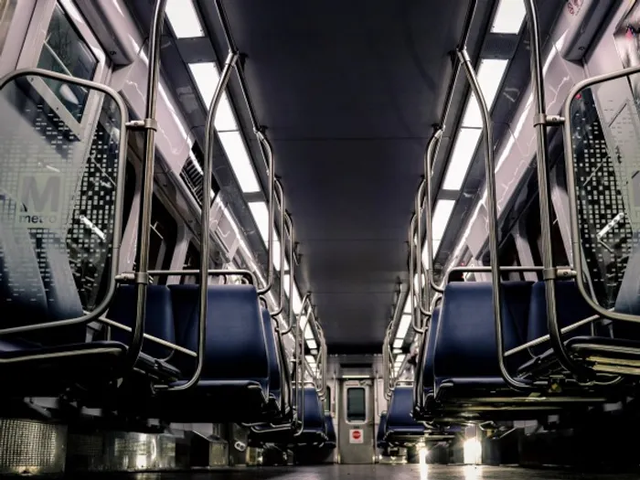 The inside of a subway car at the metro near our apartments for rent in Washington DC, featuring blue seats.