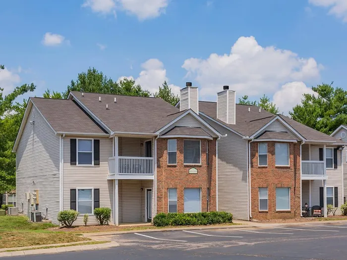 The exterior of our apartments for rent in West Nashville, TN, featuring parking spots and a view of apartment balconies.