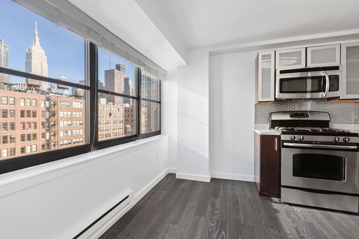 Large window view of city from kitchen