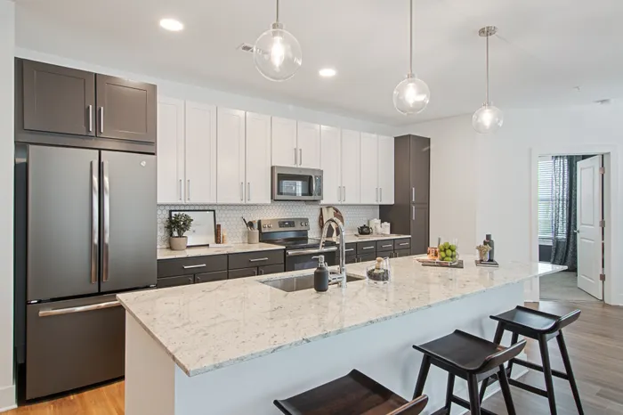 Kitchen with Stainless steel appliances and bar with seating