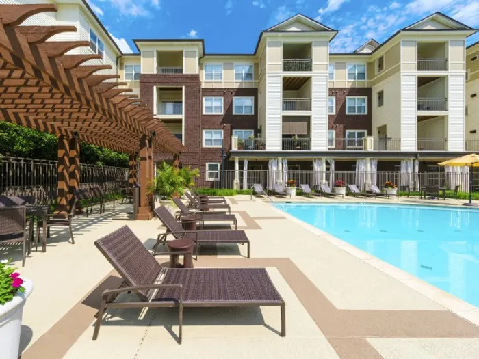 large resort style pool with seating and cabanas