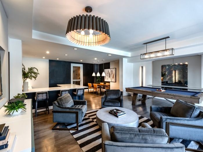 Resident lounge at our apartments for rent in Herndon, VA, featuring couches, counter seating, and billiards table.