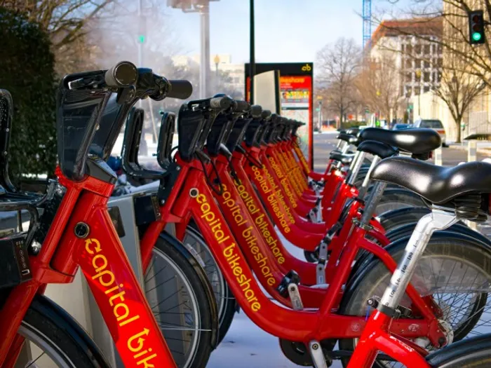 A row of rental bikes near our apartments for rent in Washington DC, featuring a view of the city streets.