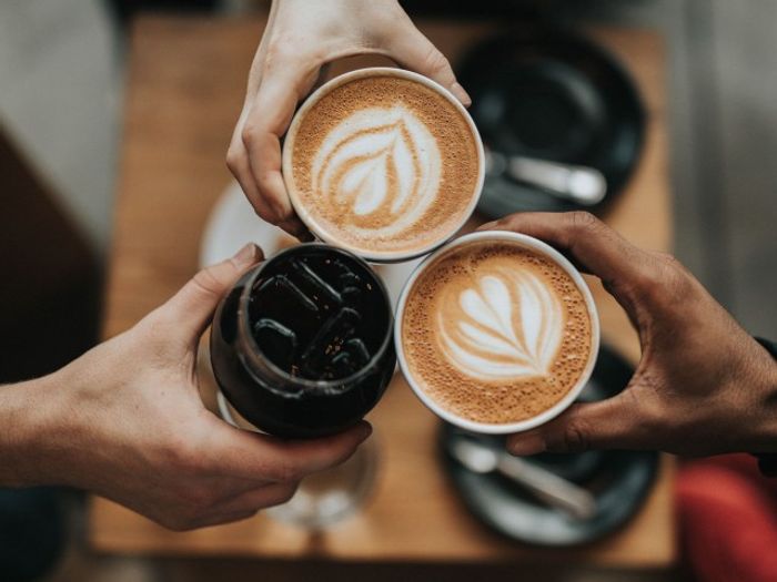 friends cheersing coffee