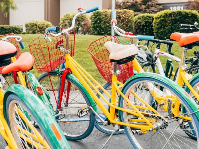 Bikes parked next to the street near our apartments for rent in Silver Spring, featuring colorful cruiser models.