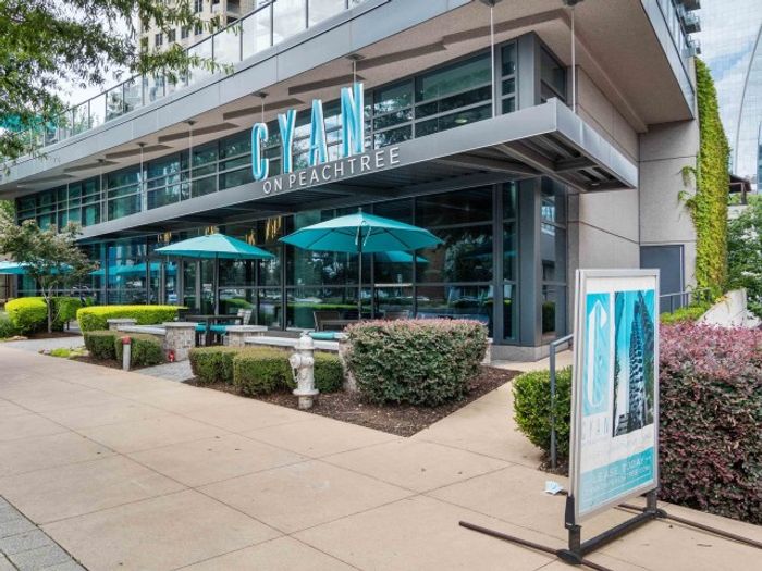The exterior of the Cyan on Peachtree apartments in Atlanta, GA, featuring a sign that reads