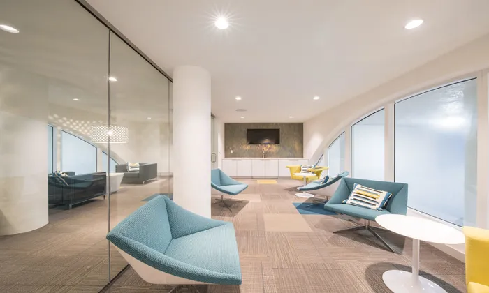 Small lounge area with blue seating inside SOMA at Brickell apartments.