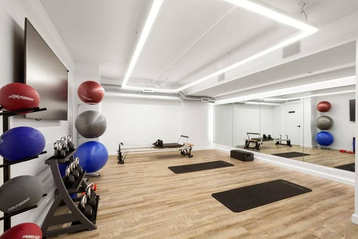 The fitness center at our apartments in Midtown Manhattan, featuring wood grain floor paneling and exercise balls.