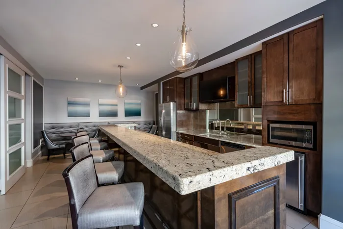 Resident lounge and dining area at our apartments in Alexandria, featuring a granite counter with seating.