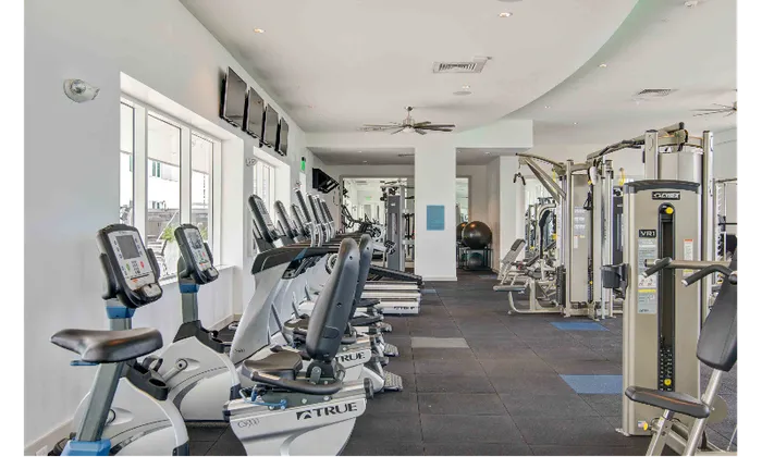 The fitness center at our apartments in Brickell, featuring treadmills, spin bikes, and other exercise equipment.