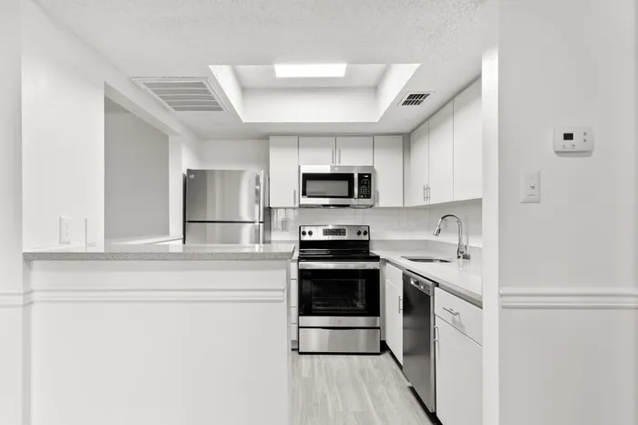 Kitchen with white cabinetry in an apartment in Clearwater, FL.