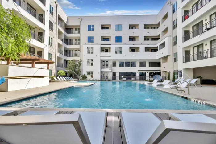 Pool with sun bathing chairs