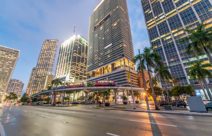 The streets of Miami near our apartments for rent in Brickell, featuring a view of the elevated train line.