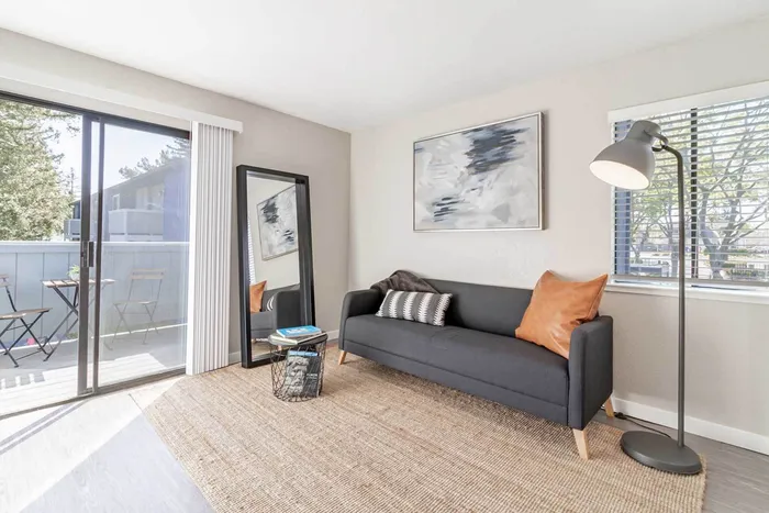 Avana Vista Point model living room with sofa, large rug, chair and TV console