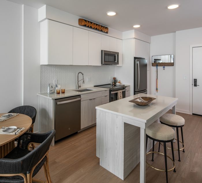 White flat front cabinetry and an open concept kitchen