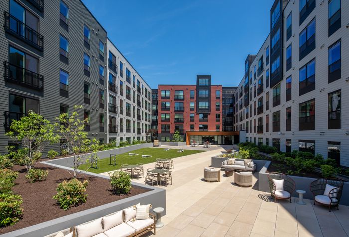 Courtyard with seating and cornhole
