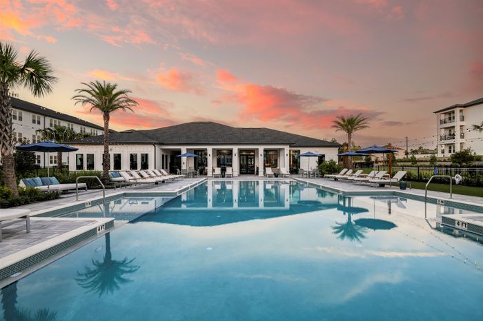 Pool courtyard and leasing clubhouse at twilight