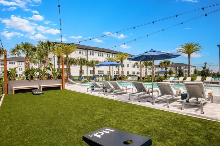 Poolside game lawn with corn hole boards
