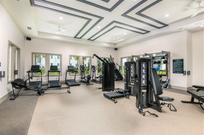 Fitness Center with tread mills, ellipticals, row machine, stair climber, and weight training