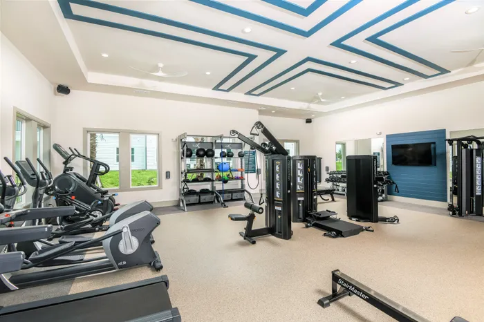 Fitness Center with tread mills, ellipticals, row machine, stair climber, and weight training
