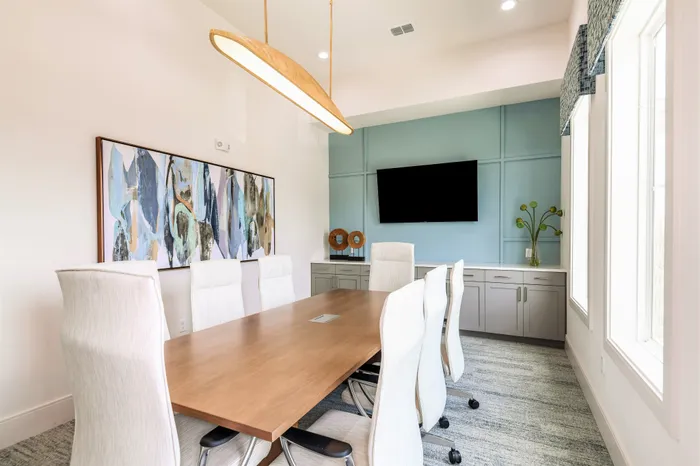 Private conference room with long table and seating for 8